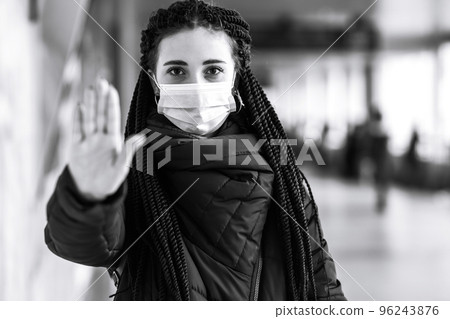 Girl in protective sterile medical mask on her face in quarantine city. Woman, wear face mask 96243876