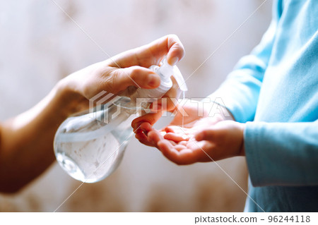 Hands with sanitizer gel. Mother and child using sanitize soap for hand coronavirus protection. Hands with sanitizer gel. Mother and child using sanitize soap for hand coronavirus protection. 96244118