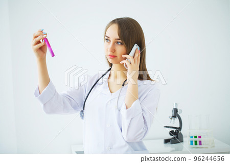 Female Scientific Research Team With Clear Solution In Laborator Female Scientific Research Team With Clear Solution In Laborator 96244656