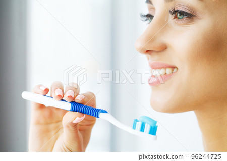 Beautiful Smiling Woman Brushing Healthy White Teeth With Brush. High Resolution Image 96244725