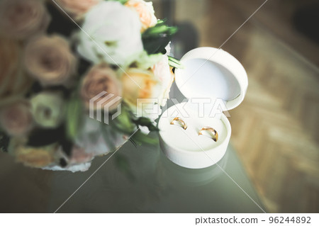 Two golden wedding rings isolated background concept Two golden wedding rings isolated background concept 96244892