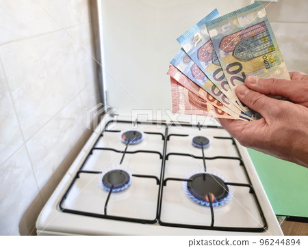 Energy efficiency concept with gas cooker and euro currency, the cost of natural gas is more expensive. Selective focus. Energy efficiency concept with gas cooker and euro currency, the cost of natural gas is more expensive. Selective focus. 96244894