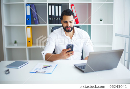 Man Working At Computer In Contemporary Office 96245041