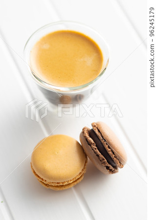 Sweet macaron dessert and coffee cup. Colorful macarons on white table. 96245179