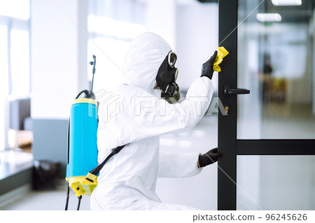 Cleaning and disinfection of office to prevent COVID-19, Man in protective hazmat suit washes office Cleaning and disinfection of office to prevent COVID-19, Man in protective hazmat suit washes office 96245626