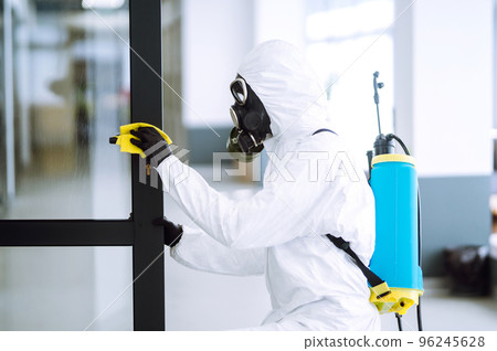 Cleaning and disinfection of office to prevent COVID-19, Man in protective hazmat suit washes office Cleaning and disinfection of office to prevent COVID-19, Man in protective hazmat suit washes office 96245628