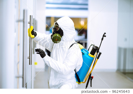 Cleaning and disinfection of office to prevent COVID-19, Man in protective hazmat suit washes office Cleaning and disinfection of office to prevent COVID-19, Man in protective hazmat suit washes office 96245643