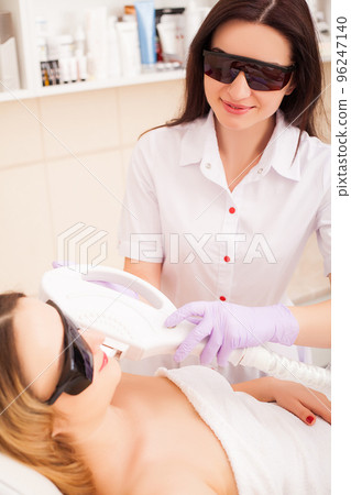 Adult woman having laser hair removal in professional beauty salon Adult woman having laser hair removal in professional beauty salon 96247140