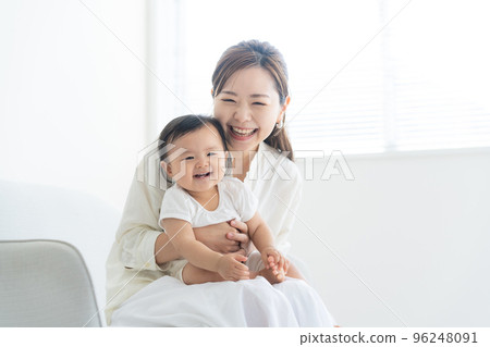A mother holding a baby A mother holding a baby 96248091