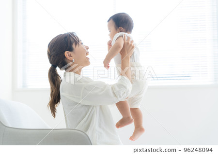 A mother holding a baby 96248094