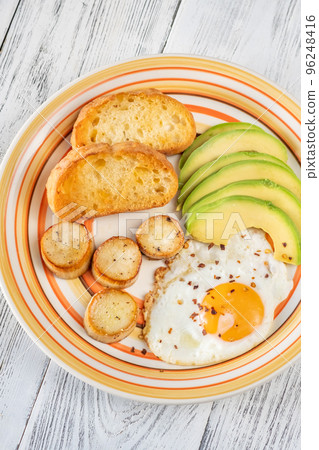 Fried eggs with avocado 96248416