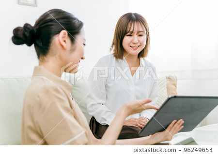 Japanese woman consulting with a counselor staff who offers counseling at a beauty salon 96249653