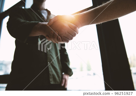 Handshaking business person in office. concept of teamwork and partnership. Handshaking business person in office. concept of teamwork and partnership. 96251927