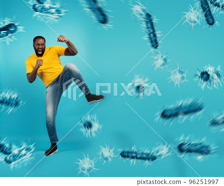 African-American man fighting with bare hands against viruses and bacteria on cyan background 96251997
