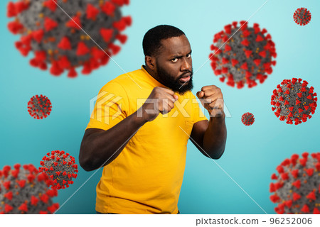 Man attacks with a punch the covid19 coronavirus. Blue background 96252006