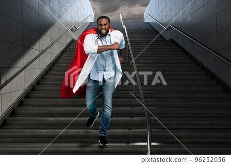 Medic acts like a superhero in hospital to fight pandemic of covid19 coronaviruses. Blue background 96252056