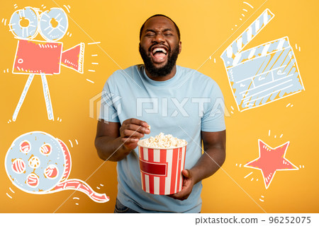 Boy has fun watching a film. Concept of entertainment and streaming tv. red background 96252075