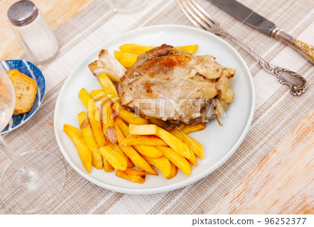 Beer roasted pork knuckle with vegetable side dish of french fries 96252377