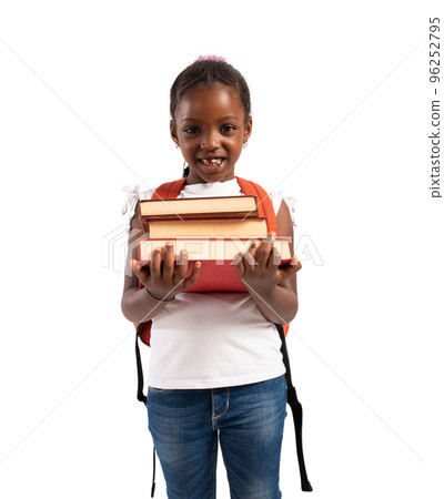 Young girl holds book and is ready to go at school Young girl holds book and is ready to go at school 96252795