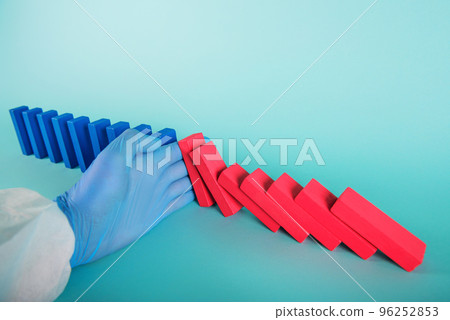 Concept of covid19 coronavirus pandemic with falling chain like a domino game. Contagion and infection progression stopped by a hand of a doctor. Cyan background 96252853