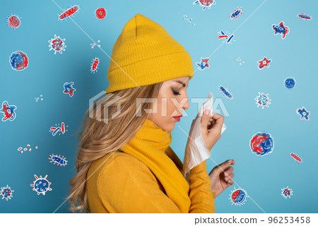 Girl caught a cold and is surrounded by viruses and bacteria. Studio on Cyan background 96253458