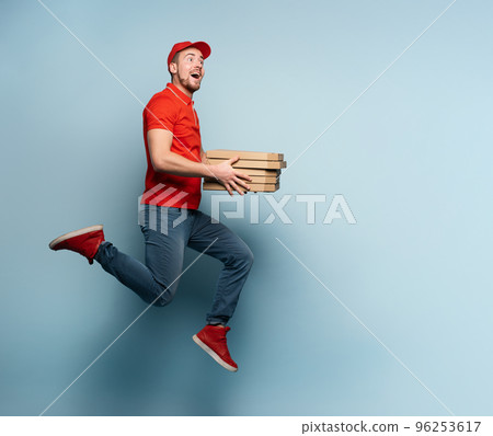 Courier runs fast to deliver quickly pizzas. Cyan background Courier runs fast to deliver quickly pizzas. Cyan background 96253617