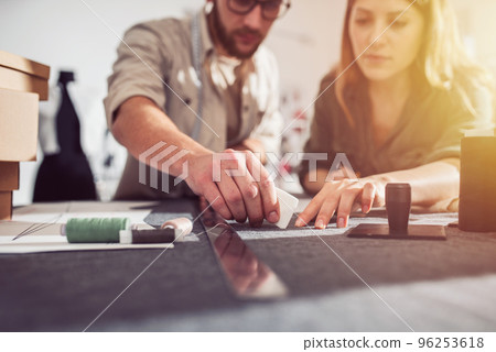 Seamstresses team ready to ship package to client with new clothes 96253618