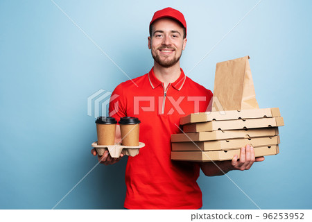 Courier is happy to deliver hot coffee and pizzas. Cyan background 96253952