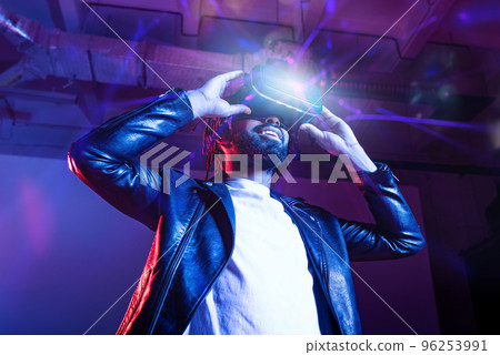 Boy with VR glasses play with a virtual videogame Boy with VR glasses play with a virtual videogame 96253991