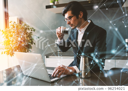 Businessman works from remote at house with a laptop due to coronavirus quarantine. Businessman works from remote at house with a laptop due to coronavirus quarantine. 96254021