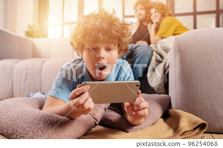 Son plays online with smartphone. Concept of addiction, dependency, problem 96254068