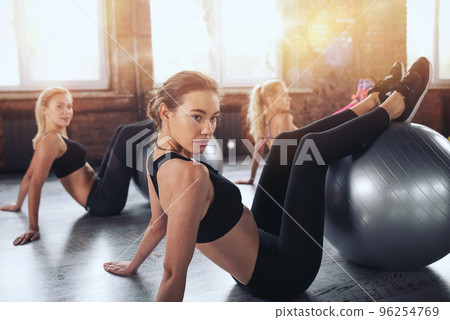 Girls do activity at the gym together. Concept of wellness and health Girls do activity at the gym together. Concept of wellness and health 96254769