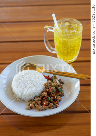 Stir fried Thai basil with minced pork and chilli on topped rice - Thai local food style Stir fried Thai basil with minced pork and chilli on topped rice - Thai local food style 96255130