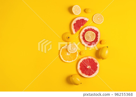 Composition of citrus fruit, orange and lemon on yellow background 96255368