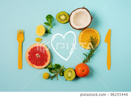 Composition of citrus fruit, orange and lemon, coconut, kiwi on cyan background Composition of citrus fruit, orange and lemon, coconut, kiwi on cyan background 96255448