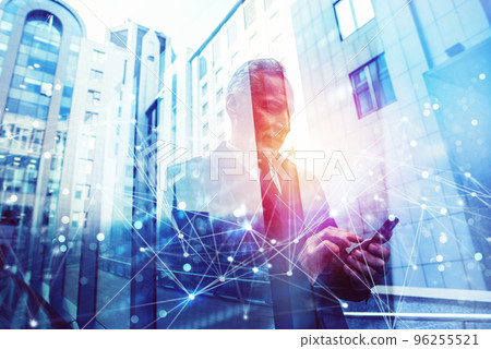 Senior businessman uses mobile phone to organize appointments. Double exposure and network effect Senior businessman uses mobile phone to organize appointments. Double exposure and network effect 96255521