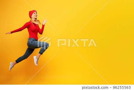 Girl runs fast. concept of energy and vitality.yellow background Girl runs fast. concept of energy and vitality.yellow background 96255563