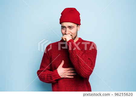 Boy caught a cold and has cough. Studio on Cyan background 96255620