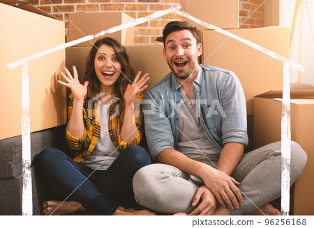 Happy couple have found a new home and they need to arrange all the packages. Concept of success, change, positivity and future 96256168