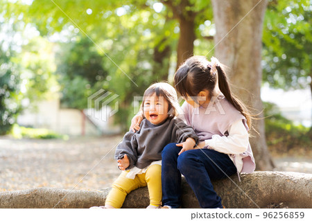 Sisters playing with each other 96256859