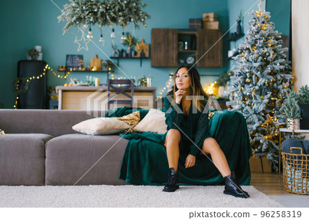 Stylish luxurious woman celebrating Christmas and new year is waiting for her loved one 96258319