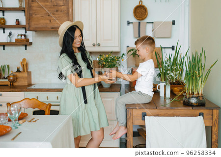 Child's son gives his mother a bouquet of flowers. Happy Mother's Day Child's son gives his mother a bouquet of flowers. Happy Mother's Day 96258334