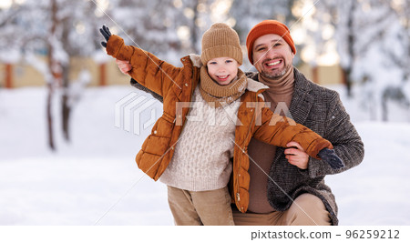 Happy father embracing little boy son while having fun in snowy weather outdoor Happy father embracing little boy son while having fun in snowy weather outdoor 96259212
