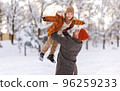 Little son having fun with dad while playing in winter park during New year and Christmas holidays 96259233