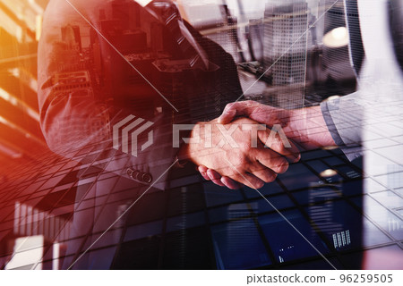 Handshaking business person in office. concept of teamwork and partnership. double exposure 96259505