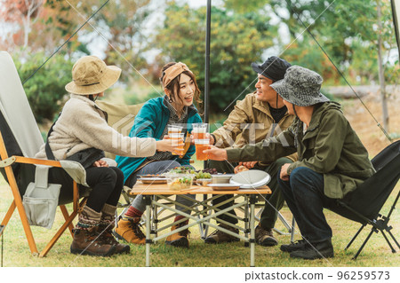 Asian man and woman relaxing and enjoying camping with friends 96259573