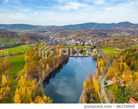 Fojtka water reservoir surrounded by vibrant colored forest at autumn time. Aerial view from drone. Fojtka water reservoir surrounded by vibrant colored forest at autumn time. Aerial view from drone. 96259989