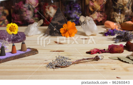 Dried Lavender and Rose Petals on Table With Incense Cones and Crystals 96260843