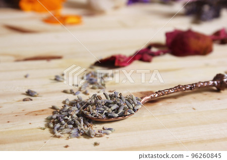 Dried Lavender and Rose Petals on Table With Incense Cones and Crystals 96260845