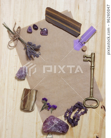 Amethyst Stones With Petrified Wood on Old Paper With Dried Flowers and Key. Purple Theme Background 96260847